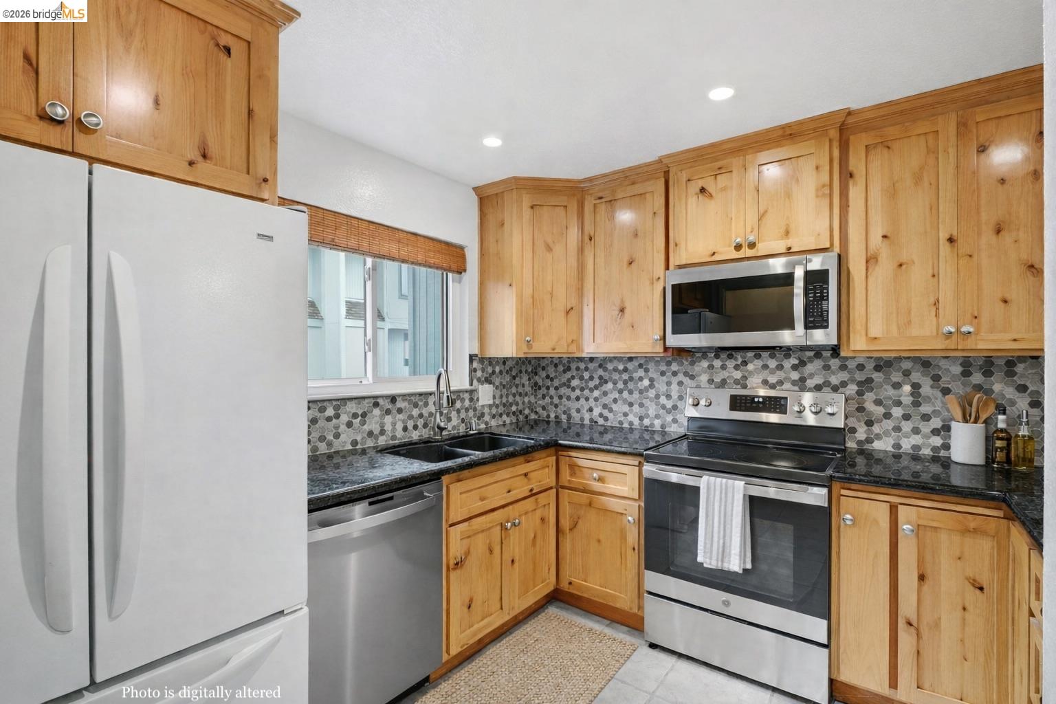18018 Sahara Road Hayward, CA 94541 - Photo 16 of 20 Kitchen featuring stainless steel appliances, light tile patterned flooring, tasteful backsplash, dark stone countertops, and recessed lighting