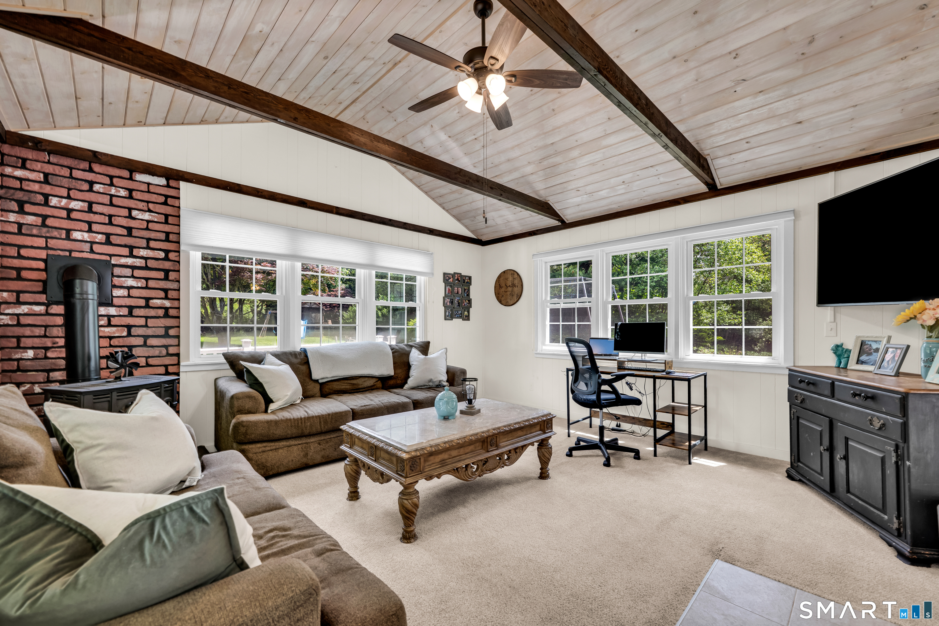 2 Hemlock Road Prospect, CT 06712 - Photo 10 of 27 a living room with furniture a flat screen tv and a large window