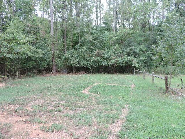 3726 Lake Road Charlotte, NC 28269 - Photo 2 of 18 a view of green field with trees in the background
