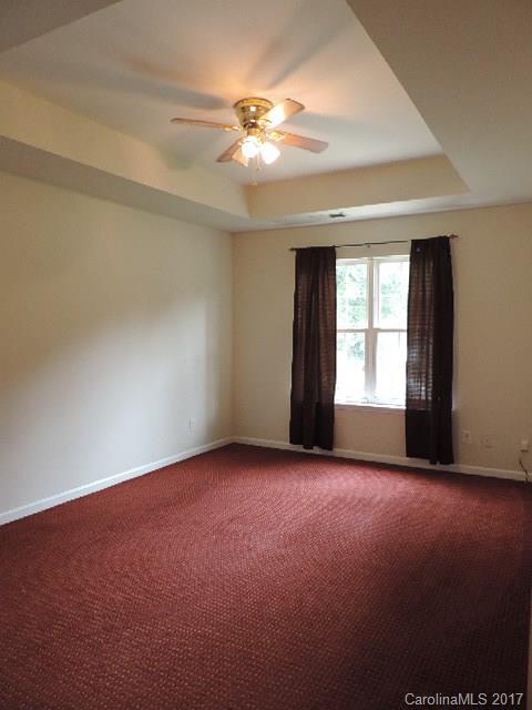 3726 Lake Road Charlotte, NC 28269 - Photo 11 of 18 an empty room with a window and a ceiling fan