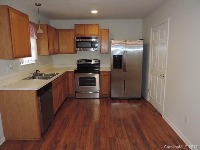 3726 Lake Road Charlotte, NC 28269 - Photo 7 of 18 a kitchen with stainless steel appliances granite countertop a stove a sink and a refrigerator