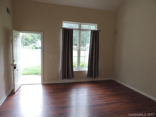 3726 Lake Road Charlotte, NC 28269 - Photo 8 of 18 a view of an empty room with wooden floor and a window