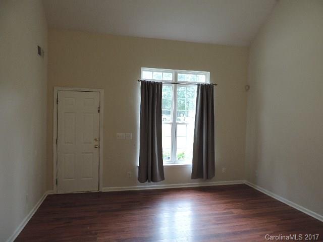 3726 Lake Road Charlotte, NC 28269 - Photo 10 of 18 an empty room with wooden floor and windows