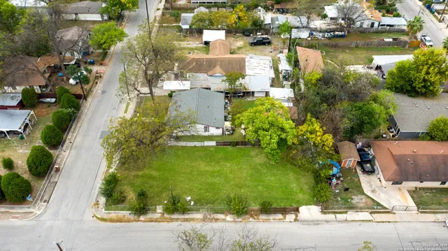 an aerial view of a house with a yard and lake view