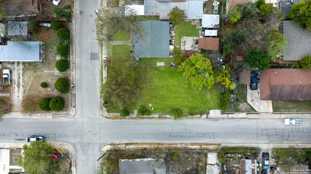 an aerial view of a house with a yard and a fountain