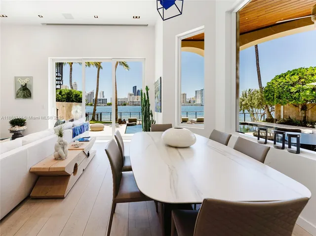 a spacious bedroom with a large bed a rug and windows