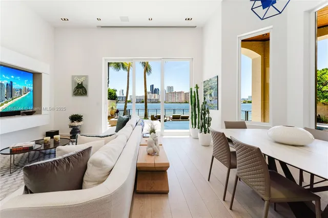 a bedroom with a bed a flat screen tv and a couch