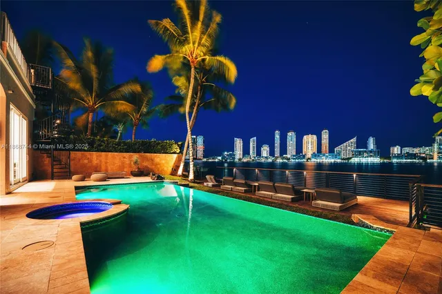 a view of a swimming pool with a lounge chairs in front of a house