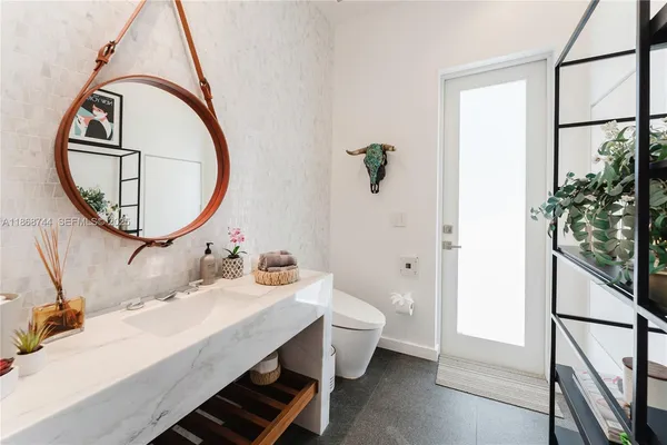 a bathroom with a tub and a view of bathroom
