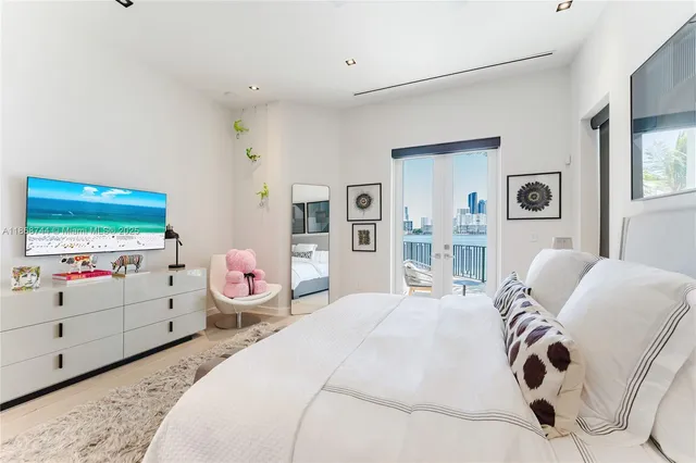 a bedroom with a bed and a wall painting