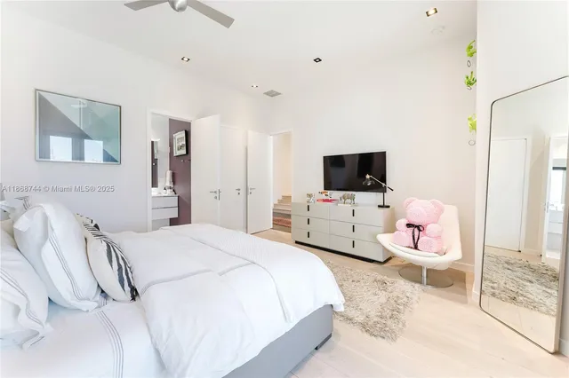 a bathroom with a granite countertop toilet sink and mirror