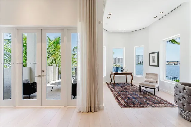 a view of a balcony with dining table and chairs