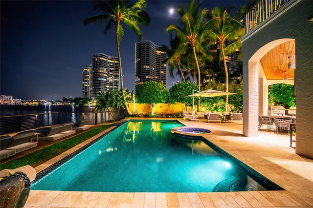 a view of a livingroom with furniture and floor to ceiling window