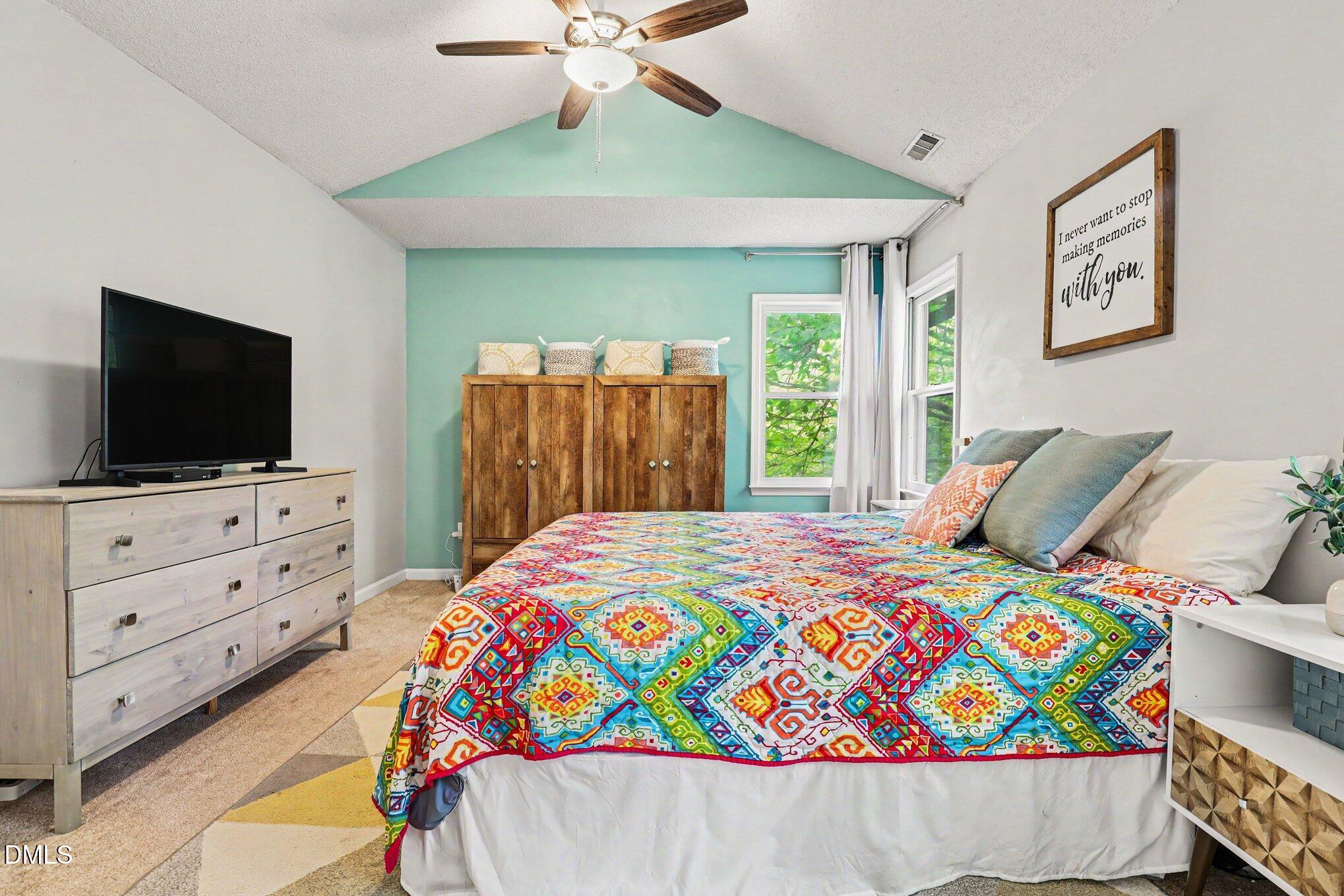 5468 Ingate Way Raleigh, NC 27613 - Photo 19 of 24 a bed room with a bed and a flat screen tv