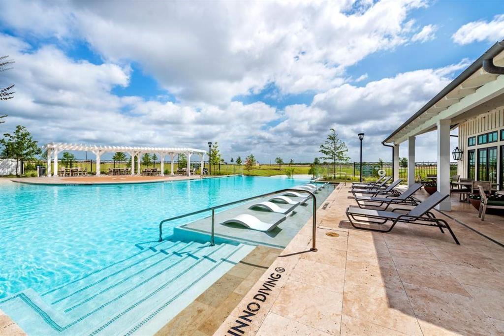 1429 Eclipse Road Aubrey, TX 76227 - Photo 32 of 37 The community features a large outdoor pool with integrated steps and several in-pool lounge chairs