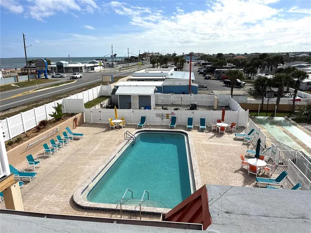 a swimming pool with outdoor seating