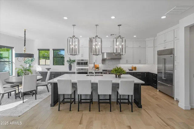 a large kitchen with a table and chairs