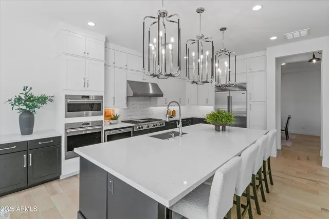 a kitchen with kitchen island a counter top space appliances and cabinets