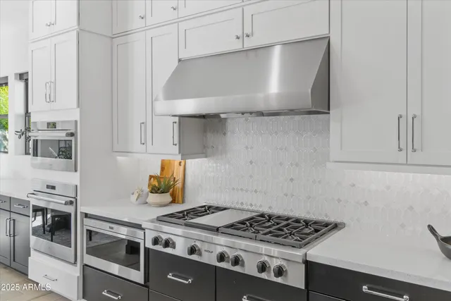 a kitchen with granite countertop a stove and a refrigerator