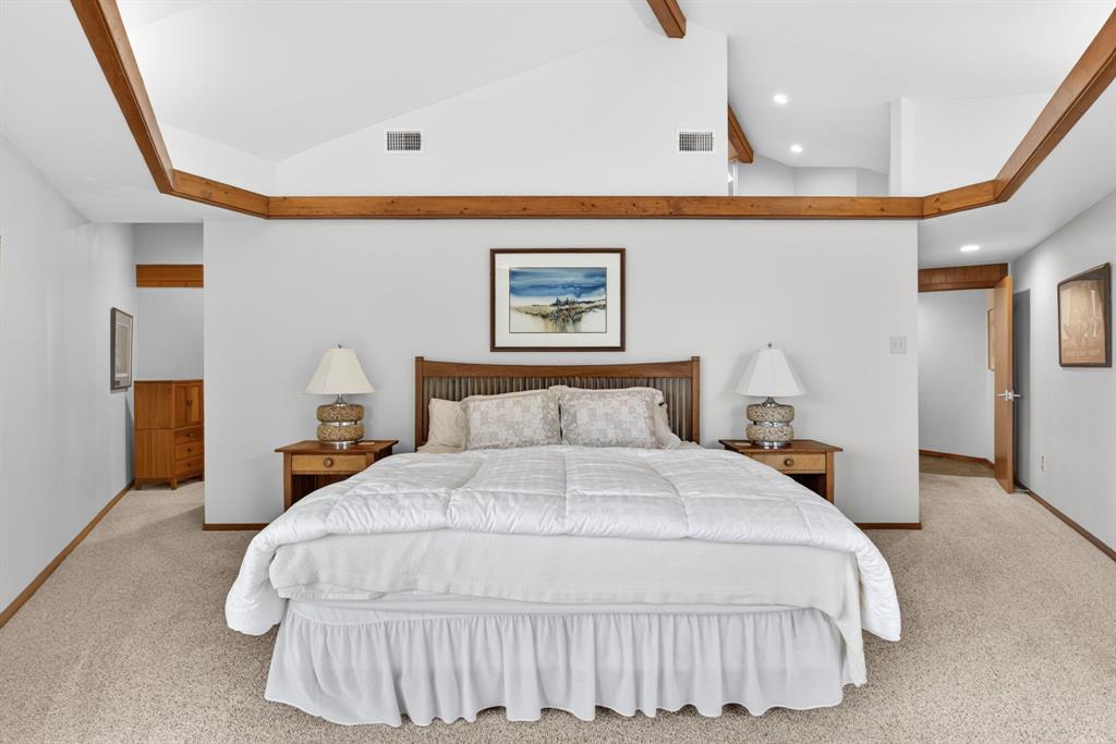 1080 North Greenbrier Road Nocona, TX 76255 - Photo 17 of 40 Spacious bedroom featuring vaulted ceilings with exposed wood beams, light-toned carpeting, and recessed lighting