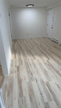 an empty room with wooden floor