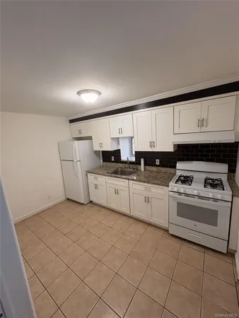 a kitchen with cabinets and white appliances