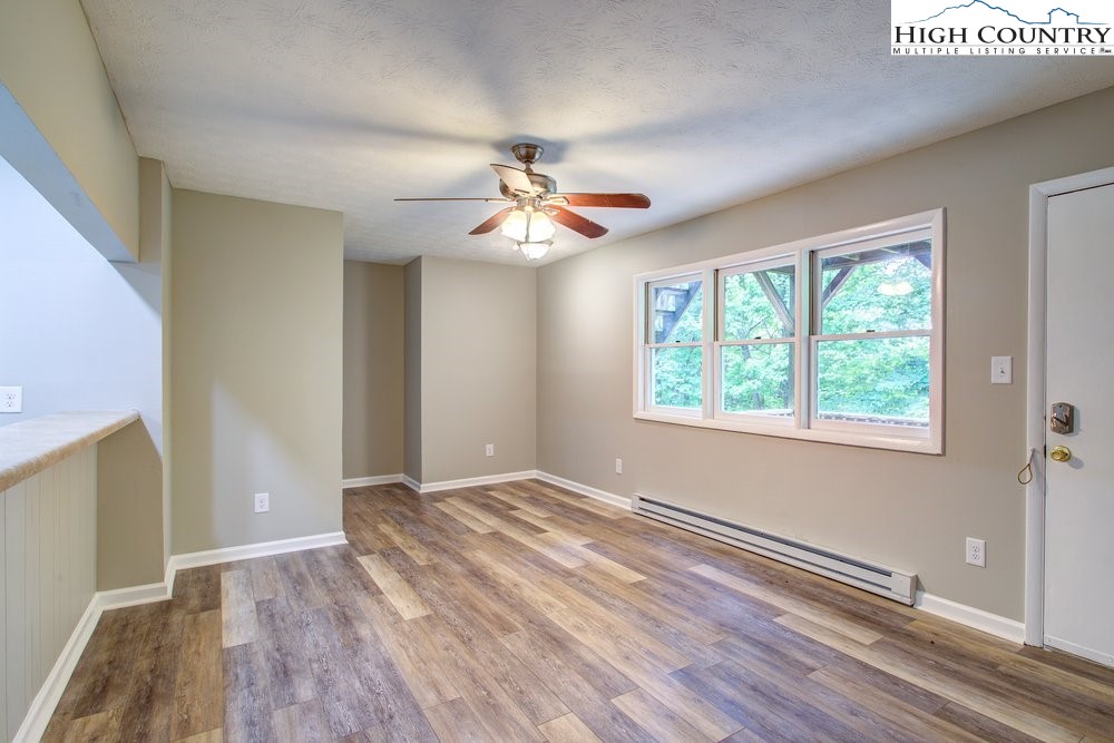 591-573 Margot Road Boone, NC 28607 - Photo 4 of 15 wooden floor in an empty room with a window