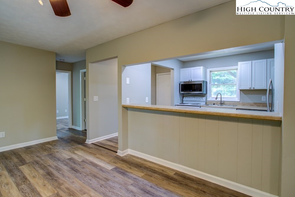 591-573 Margot Road Boone, NC 28607 - Photo 6 of 15 a kitchen with granite countertop a sink and a stove top oven