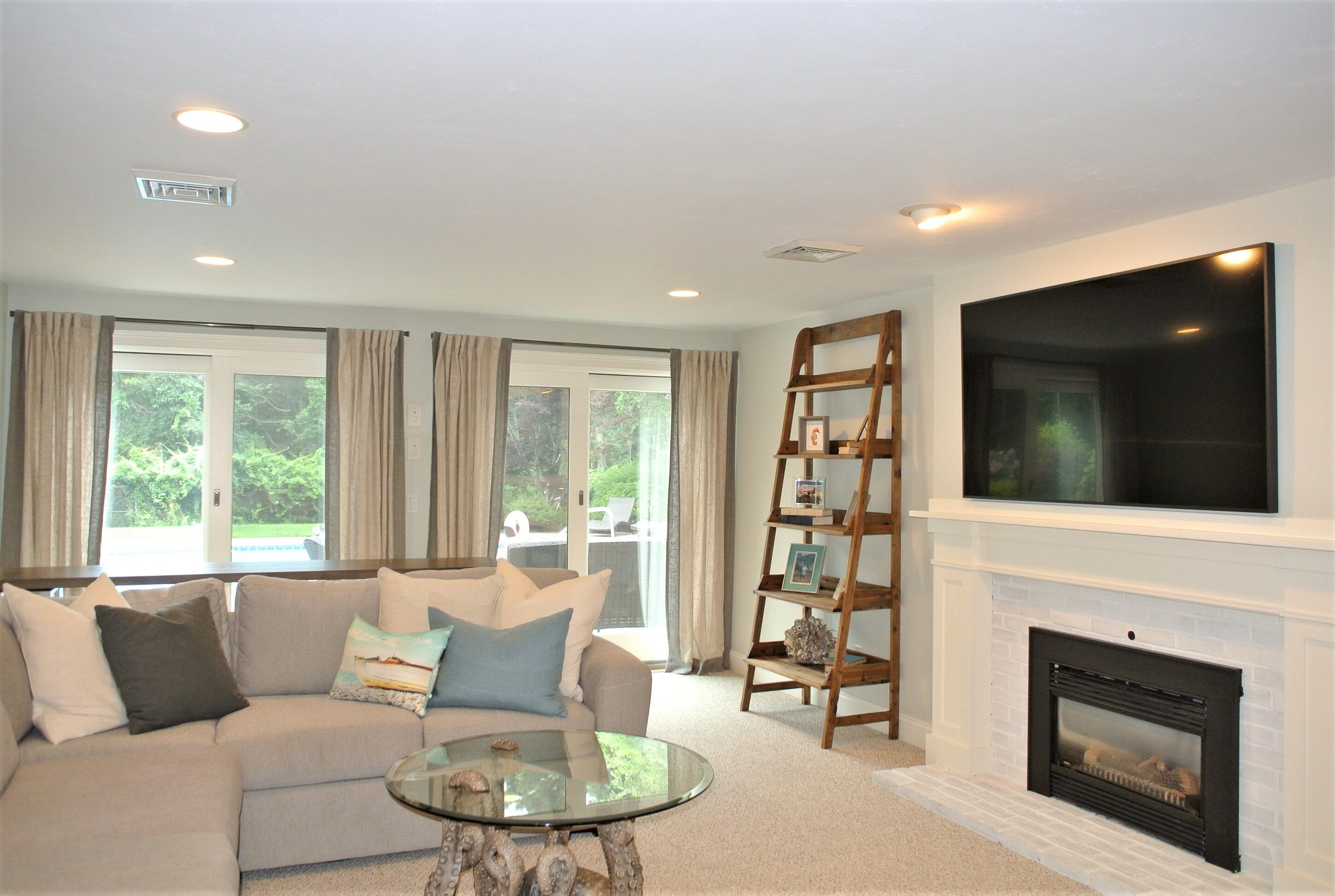 47 The Hunt Circle Mashpee, MA 02649 - Photo 54 of 73 a living room with furniture a flat screen tv and a fireplace