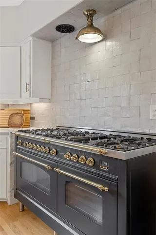 a stove top oven sitting inside of a kitchen
