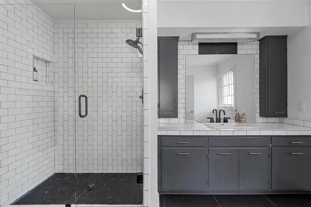 a bathroom with a granite countertop sink a toilet and mirror