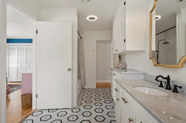 a kitchen with granite countertop a sink and a refrigerator