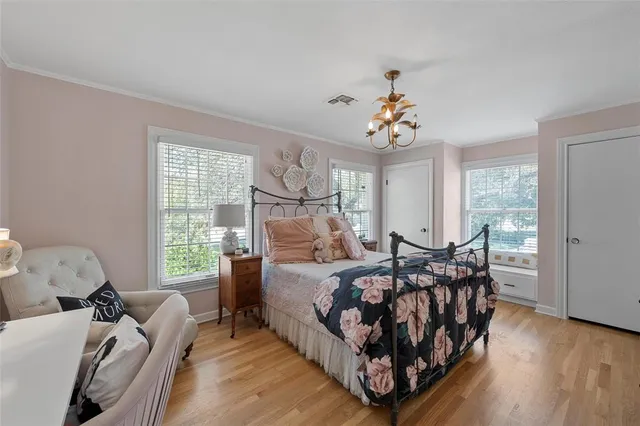 a bed room with a bed and a chair