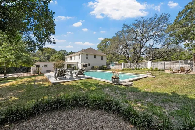 a view of a house with swimming pool and sitting area