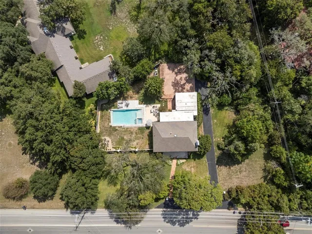 an aerial view of a house with yard