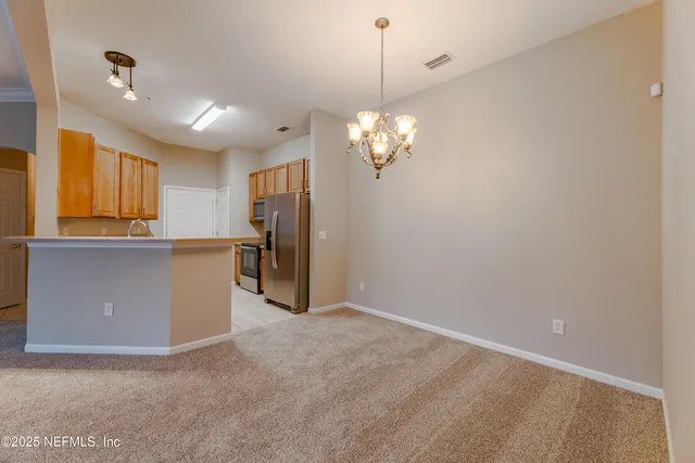 a view of a kitchen with a refrigerator a sink and dishwasher