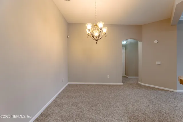 a view of a chandelier in big room and chandelier