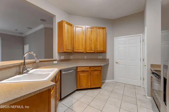 a kitchen with stainless steel appliances granite countertop a sink and a stove top oven