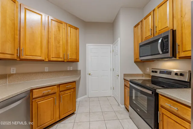 a kitchen with stainless steel appliances granite countertop a stove microwave and cabinets