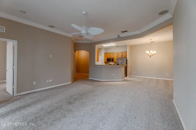 a view of a livingroom with furniture and a ceiling fan