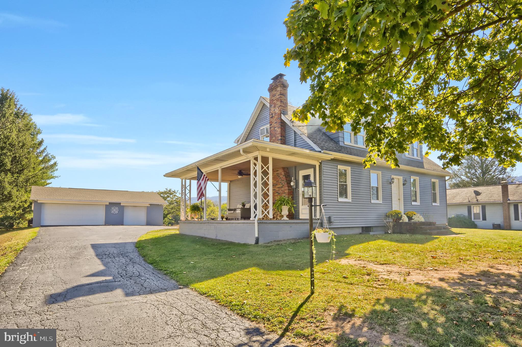 3209 Peters Mountain Road Halifax, PA 17032 - Photo 3 of 56 a front view of a house with a yard table and chairs