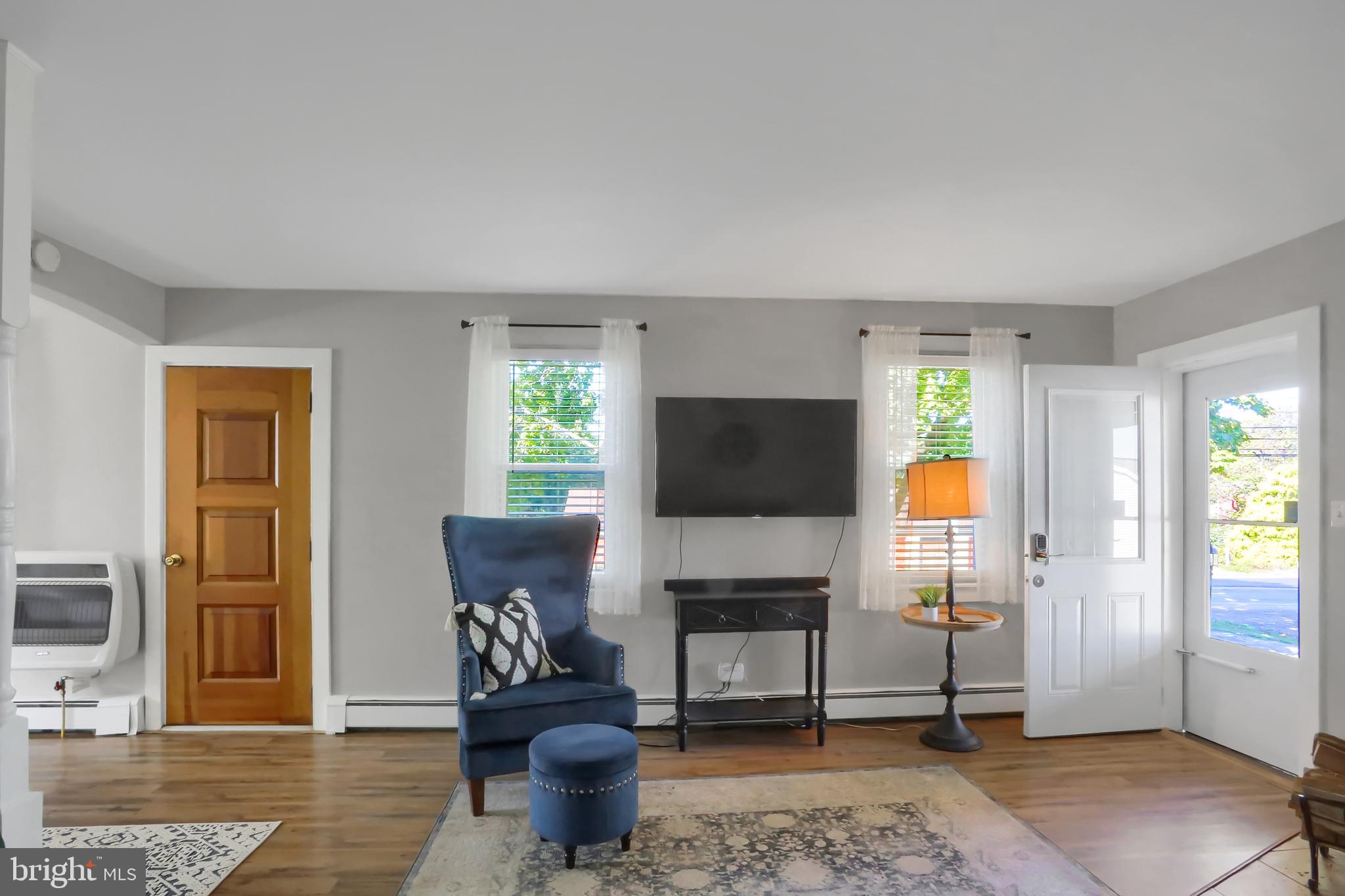 3209 Peters Mountain Road Halifax, PA 17032 - Photo 7 of 56 a living room with furniture a flat screen tv and a window