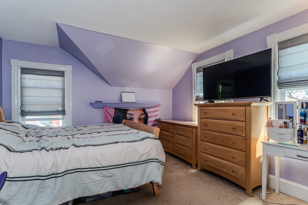 50 Duryea Street Springfield, MA 01104 - Photo 16 of 29 a bedroom with a bed and flat screen tv