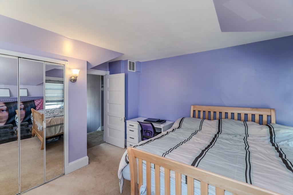 50 Duryea Street Springfield, MA 01104 - Photo 17 of 29 a bedroom with a bed and a table