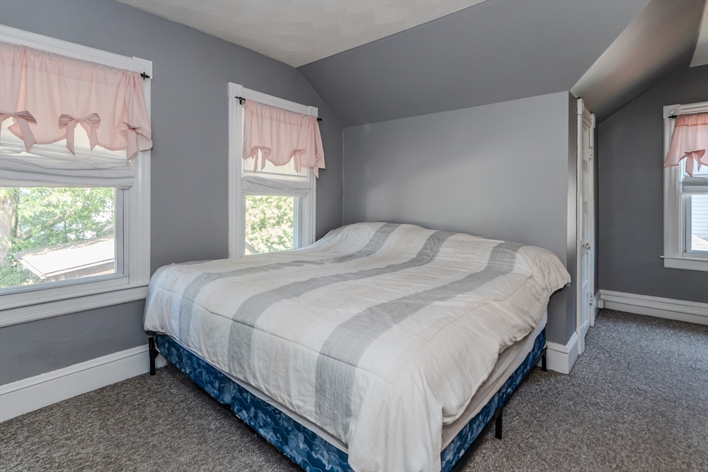 50 Duryea Street Springfield, MA 01104 - Photo 18 of 29 a large bed sitting in a bedroom next to a window