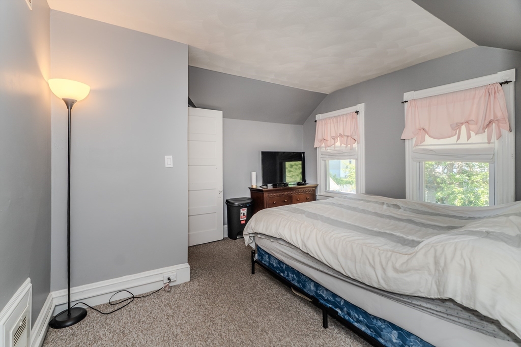 50 Duryea Street Springfield, MA 01104 - Photo 19 of 29 a bedroom with a bed and a lamp