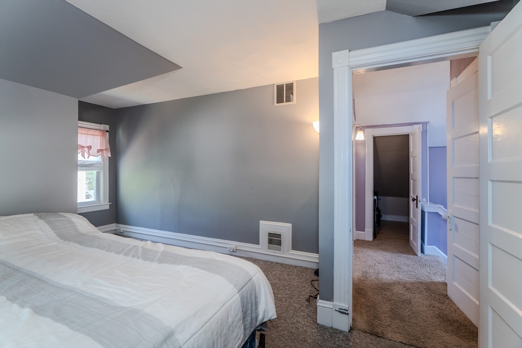 50 Duryea Street Springfield, MA 01104 - Photo 20 of 29 a bedroom with a bed and a window