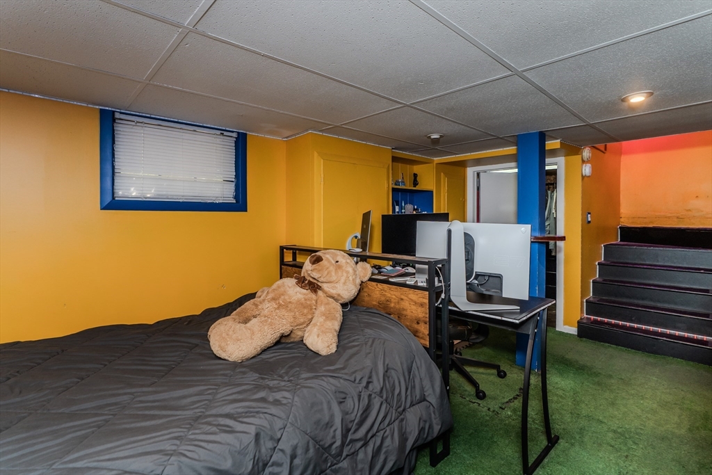 50 Duryea Street Springfield, MA 01104 - Photo 22 of 29 a bed room with furniture and a flat screen tv