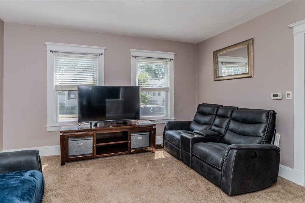 50 Duryea Street Springfield, MA 01104 - Photo 4 of 29 a living room with furniture and a flat screen tv