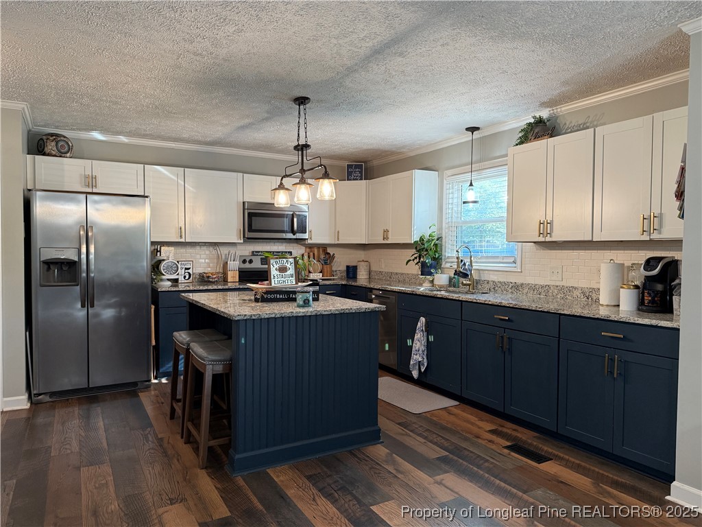 3057 Westminster Road Lumberton, NC 28360 - Photo 13 of 35 a kitchen with kitchen island granite countertop a sink cabinets and stainless steel appliances